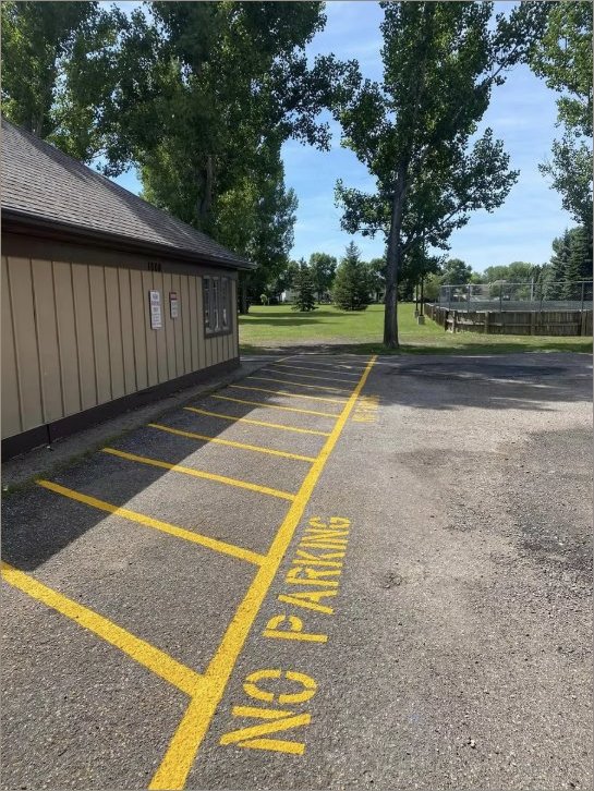 Municipal park lot with yellow NO PARKING stencil in Fargo, ND