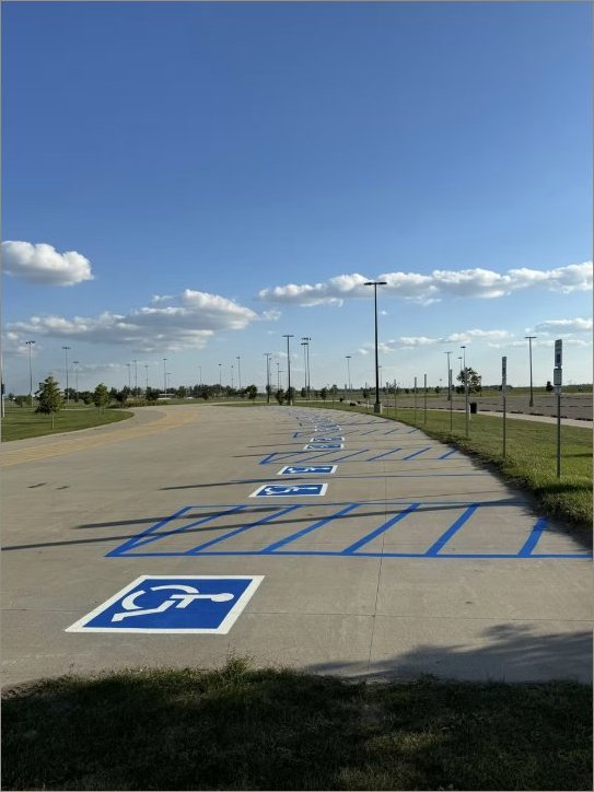 Municipal park lot with long row of ADA accessible spaces