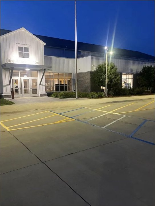 School entrance parking lot at dusk