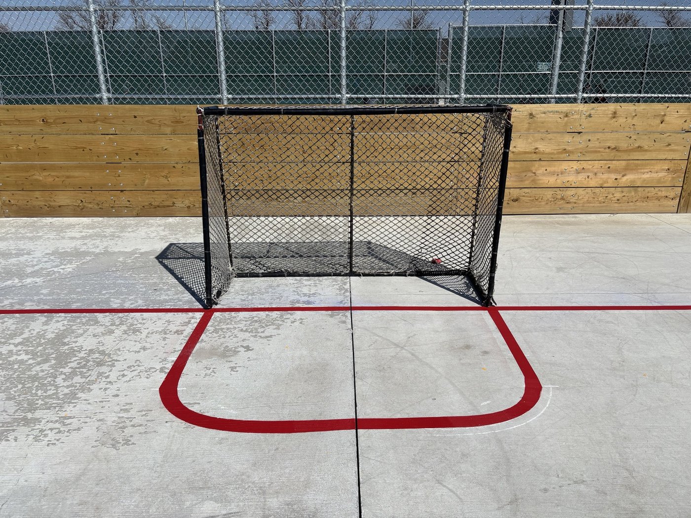 Outdoor hockey rink with red and blue painted lines
